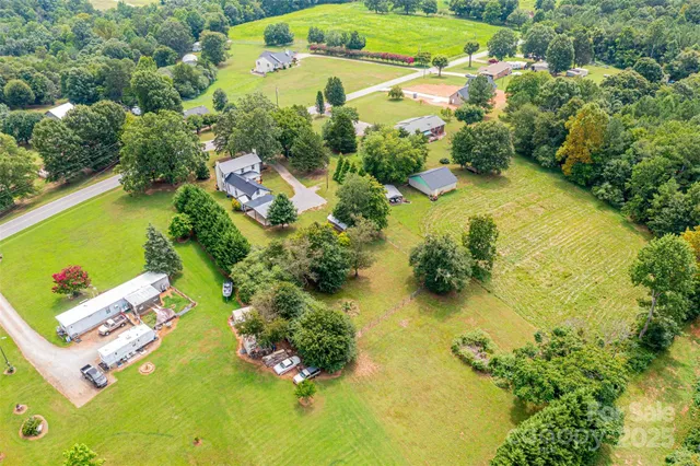 an aerial view of residential house with swimming pool and garden