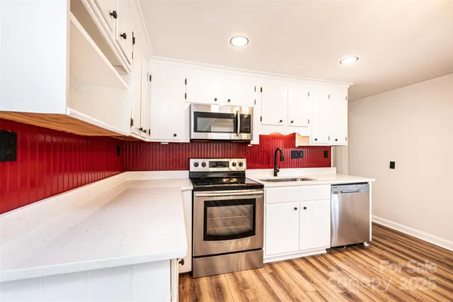 a kitchen with stainless steel appliances a refrigerator sink and cabinets
