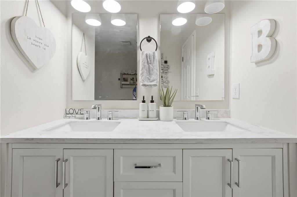 404 Brooks Street Dallas, GA 30157 - Photo 19 of 38 a bathroom with a double vanity sink and a mirror
