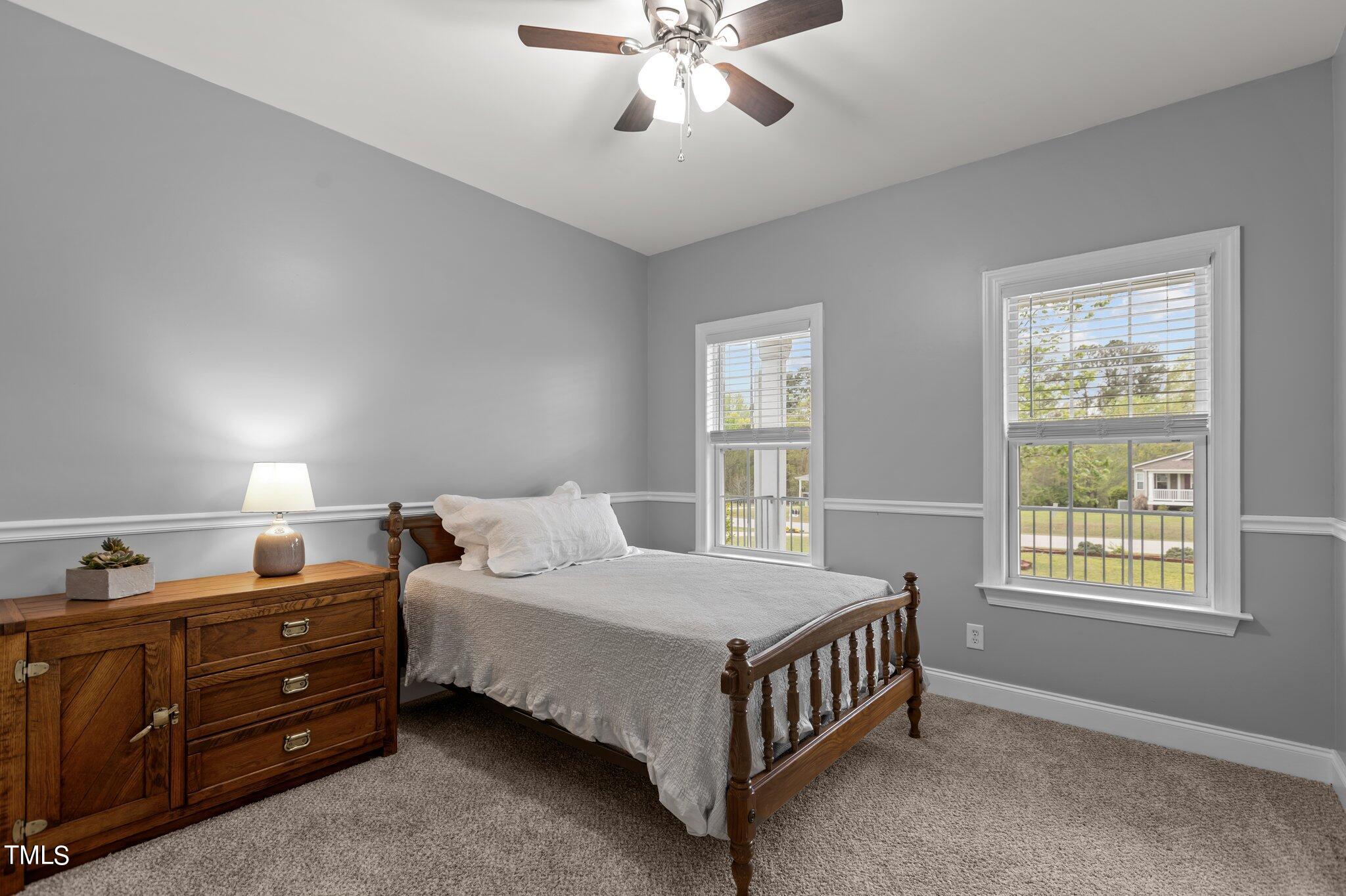 148 Ina Joe Place Willow Spring, NC 27592 - Photo 14 of 41 a bedroom with a bed and window