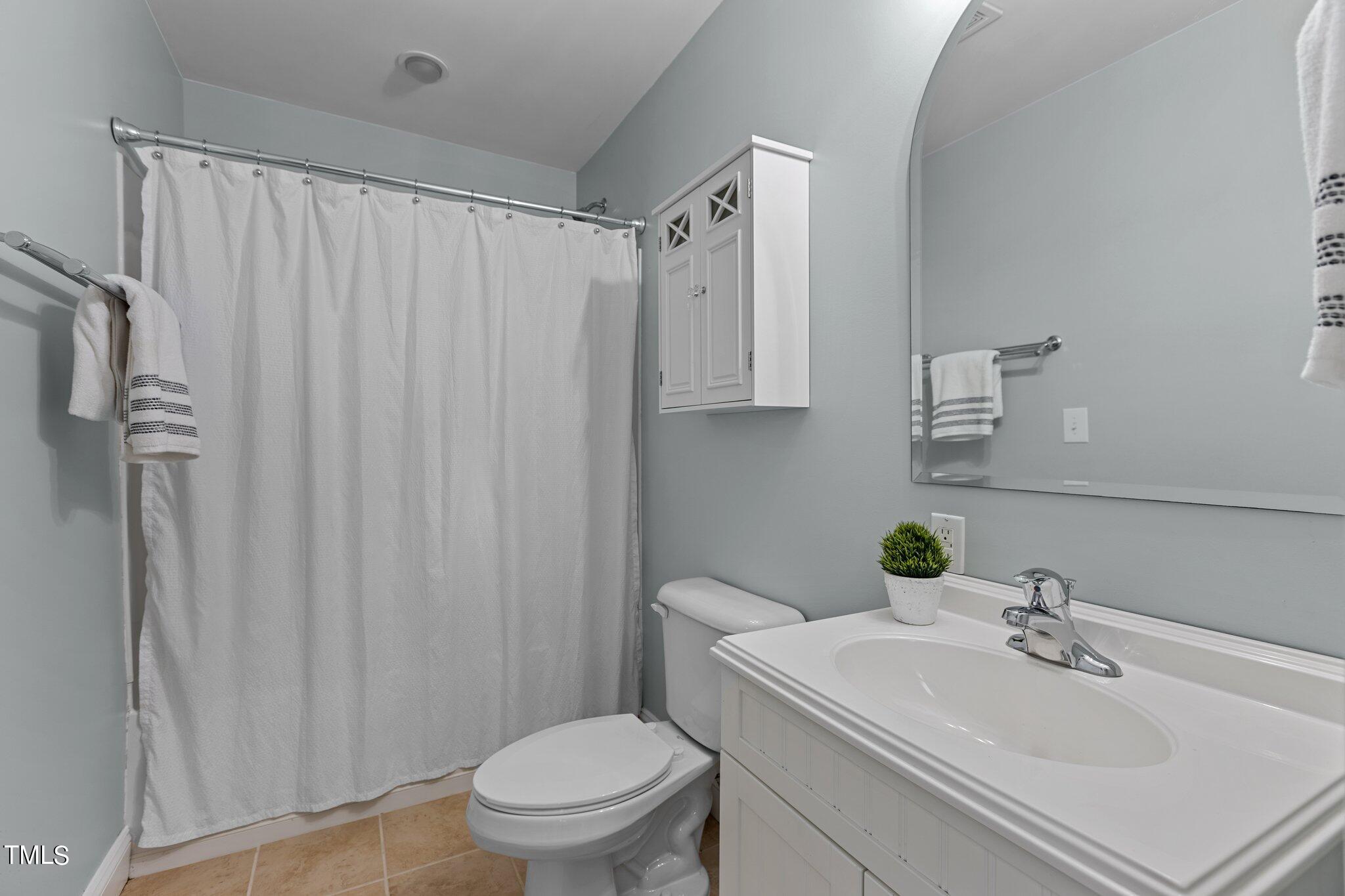 148 Ina Joe Place Willow Spring, NC 27592 - Photo 32 of 41 a bathroom with a sink toilet and shower