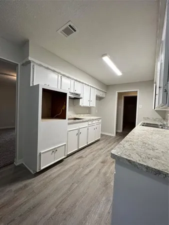 a kitchen with stainless steel appliances kitchen island wooden cabinets and granite counter tops