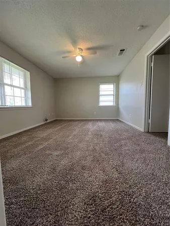 an empty room with windows and closet