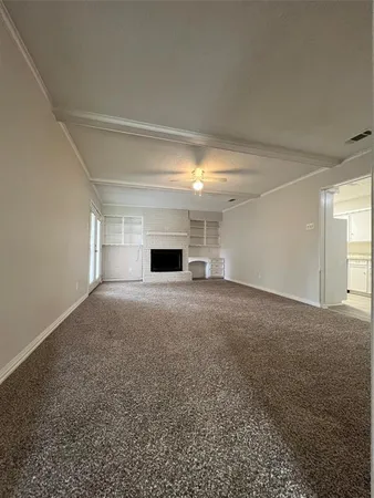a view of empty room with a fireplace