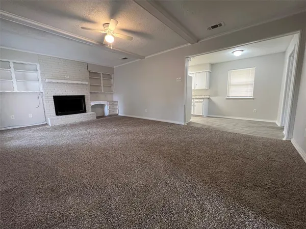 a view of empty room with a fireplace