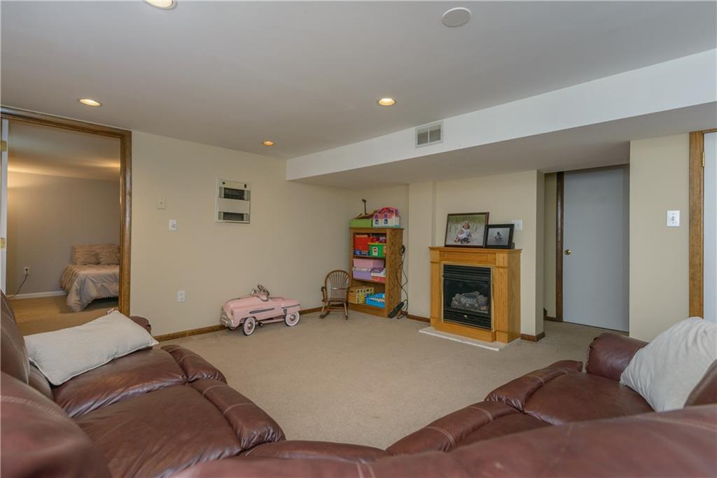 405 Oliver Road Sewickley, PA 15143 - Photo 20 of 25 Lower level family room boasts a second fireplace and lots of room for entertaining.