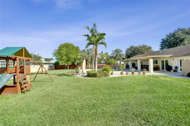 a view of a house with backyard porch and sitting area