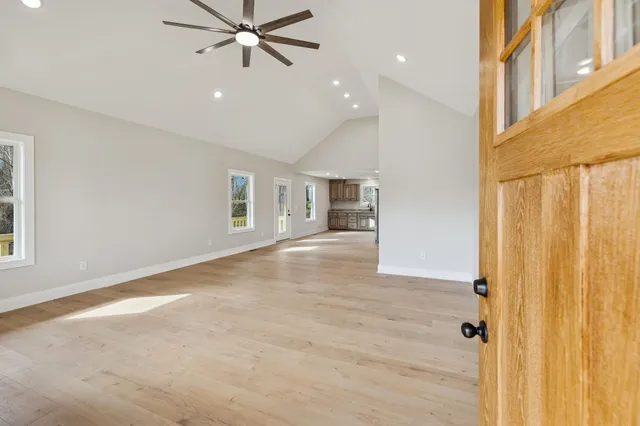a view of a hallway with wooden floor and entryway