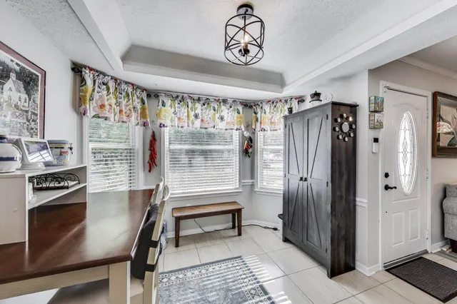 a view of kitchen with stainless steel appliances granite countertop a stove and a refrigerator