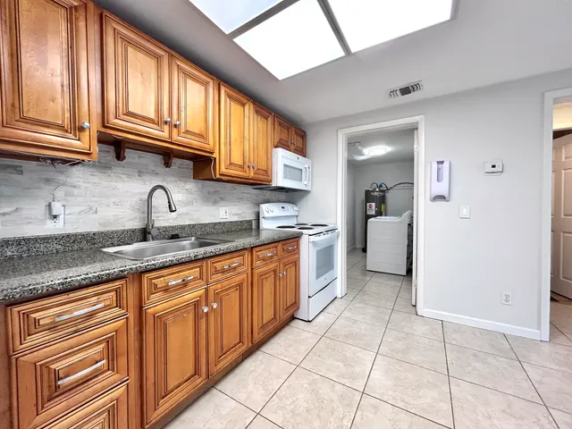 a kitchen with stainless steel appliances granite countertop a sink and cabinets