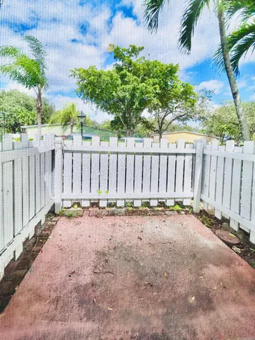 a view of a backyard with wooden fence
