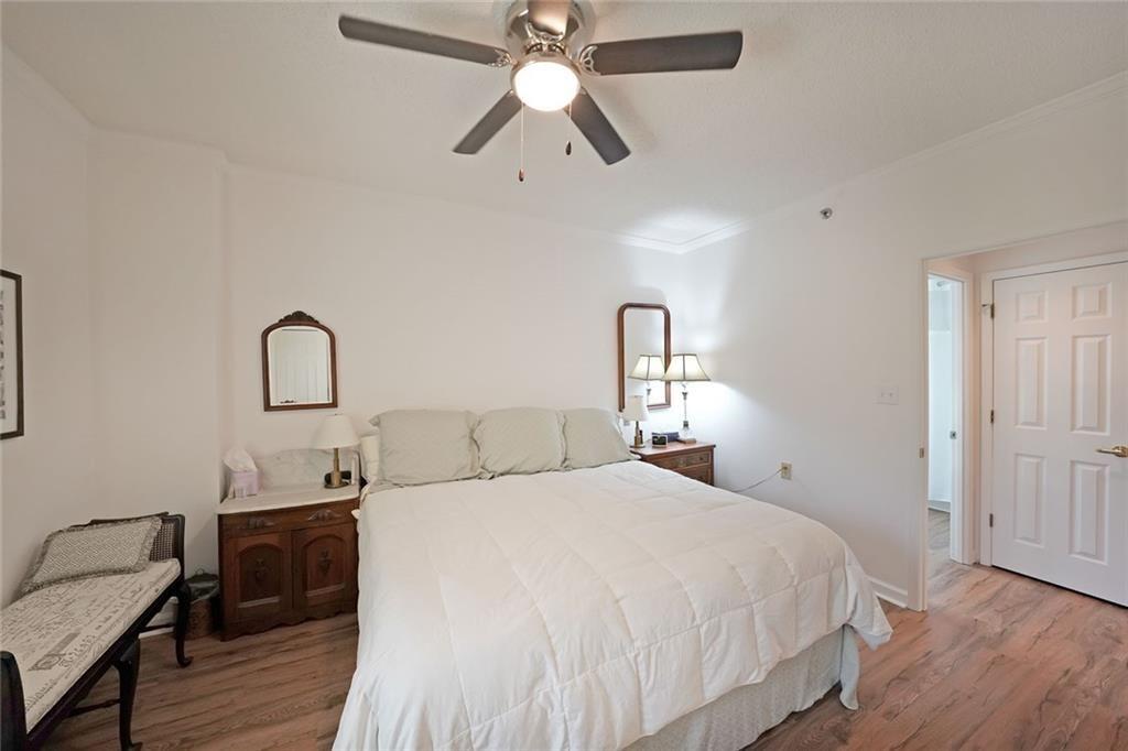 1800 Clairmont Lake, Unit A522 Decatur, GA 30033 - Photo 19 of 36 a bedroom with a bed and a chandelier