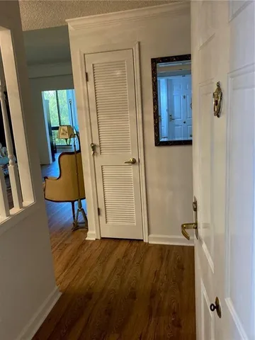 a view of an entryway with wooden floor and mirror