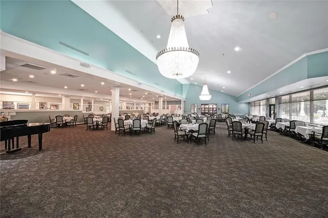 a view of a room with gym equipment and large windows