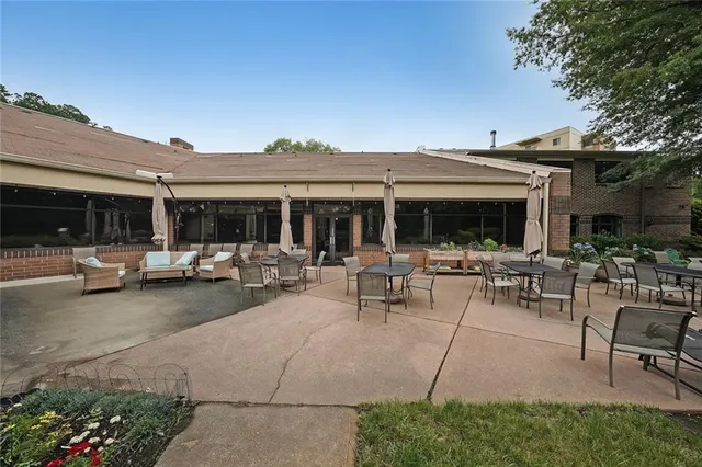 a view of the patio with table and chairs and potted plants