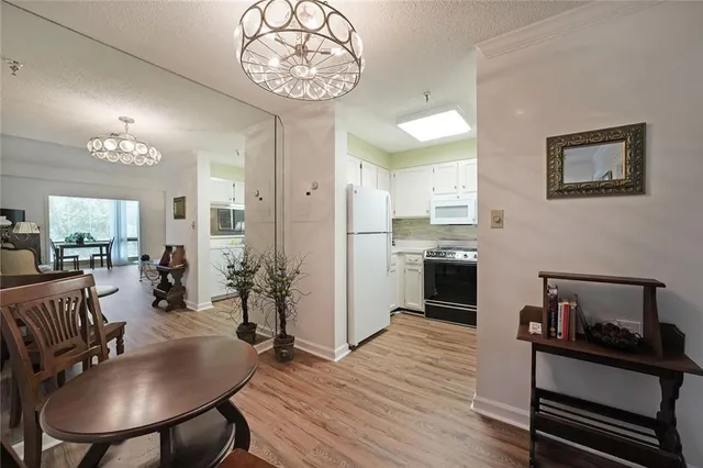 a kitchen with sink refrigerator and cabinets