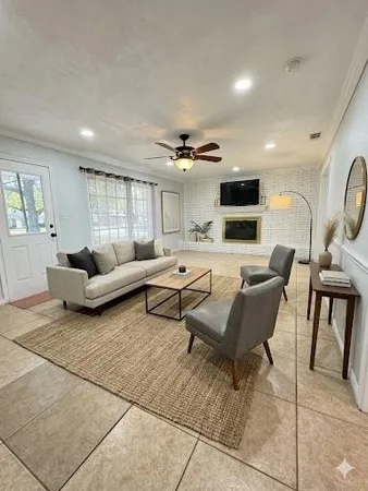 a living room with furniture and a flat screen tv