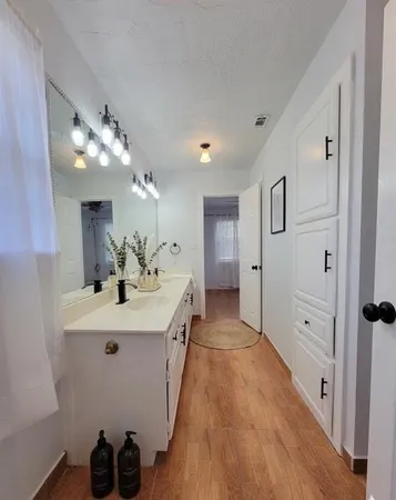 a spacious bathroom with a double vanity sink and mirror