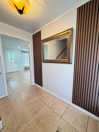 a view of a hallway to rooms