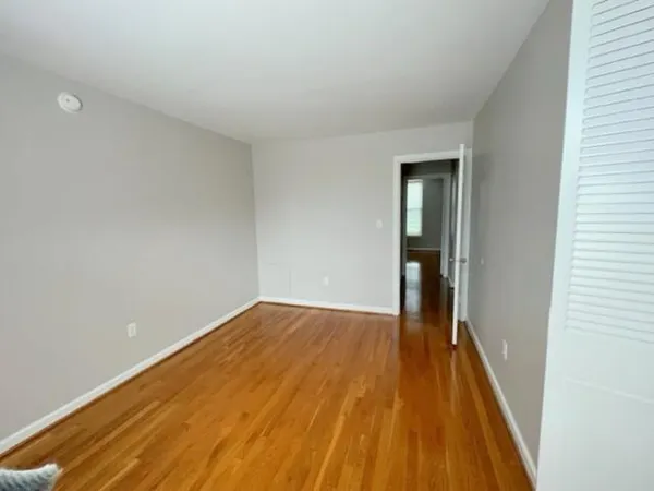 a view of a room with wooden floor and stairs