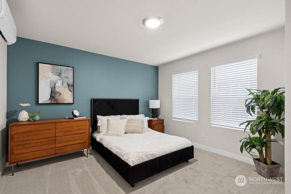 23413 Edmonds Way, Unit E4 Edmonds, WA 98026 - Photo 18 of 22 a bedroom with a bed and a potted plant