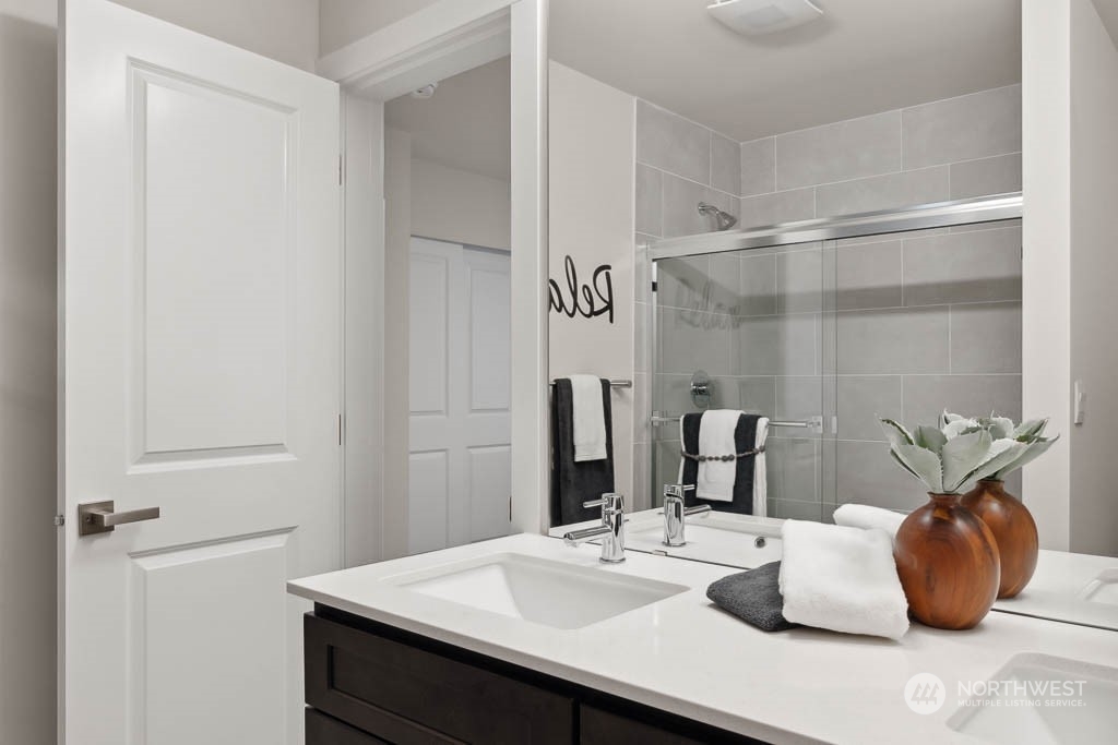 23413 Edmonds Way, Unit E4 Edmonds, WA 98026 - Photo 21 of 22 a bathroom with a sink and a mirror