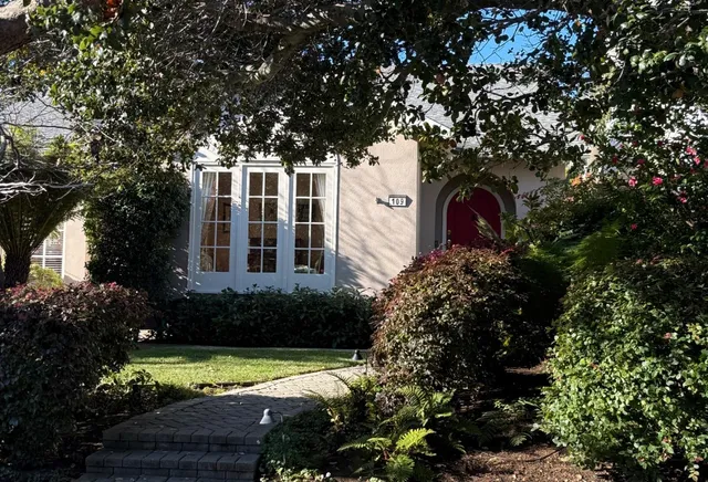 a front view of a house with garden