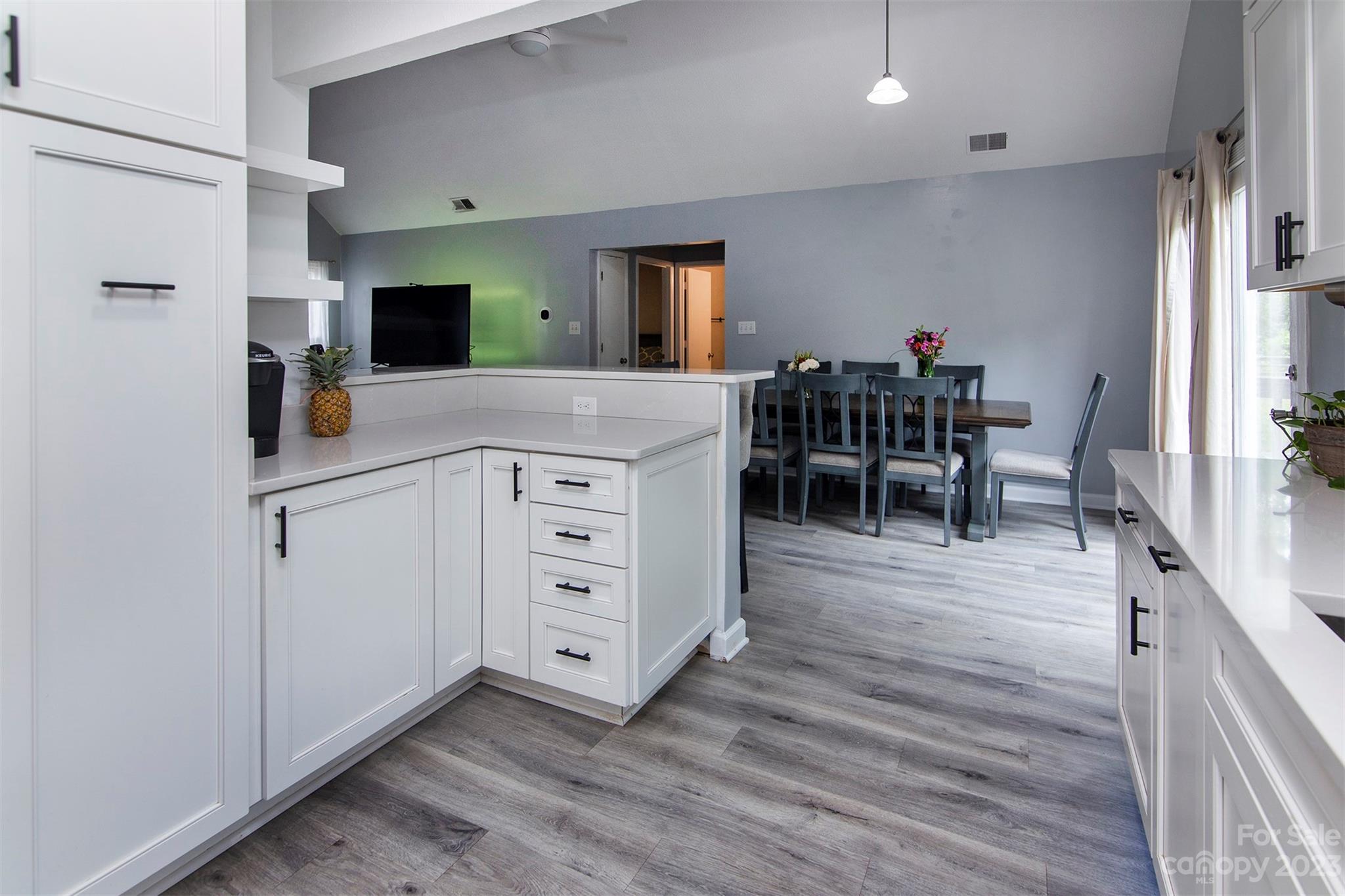 8014 Red Lantern Road Indian Trail, NC 28079 - Photo 12 of 24 a kitchen with white cabinets and stainless steel appliances