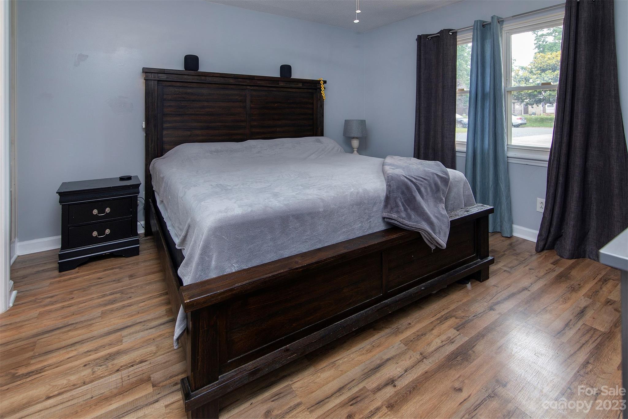 8014 Red Lantern Road Indian Trail, NC 28079 - Photo 13 of 24 a bedroom with a bed and wooden floor