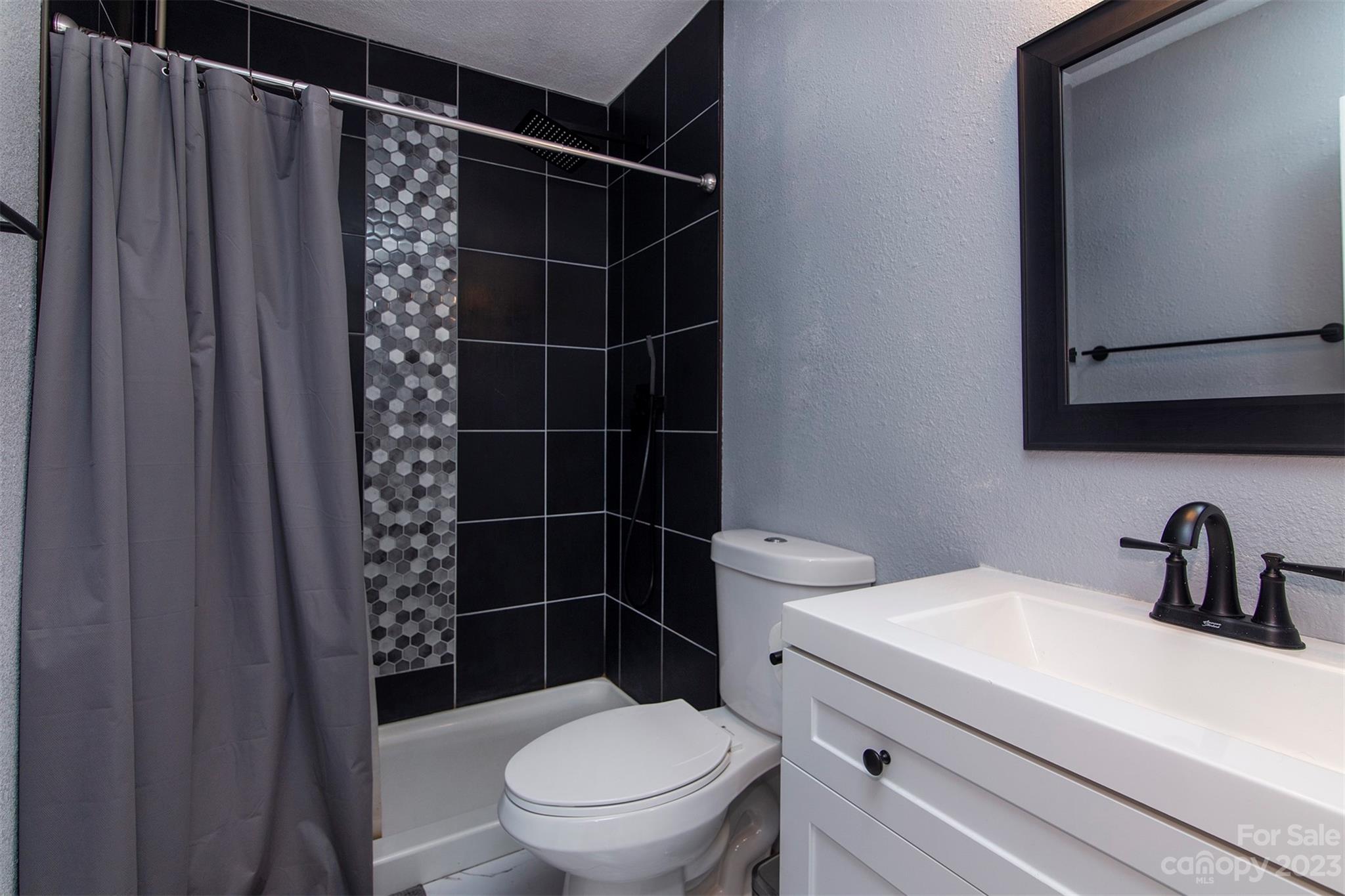 8014 Red Lantern Road Indian Trail, NC 28079 - Photo 18 of 24 a bathroom with a toilet a sink and shower