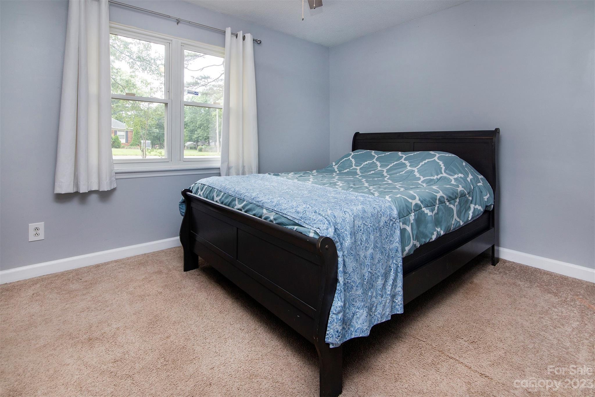 8014 Red Lantern Road Indian Trail, NC 28079 - Photo 19 of 24 a bed sitting in a bedroom next to a window