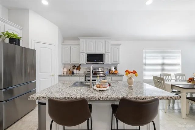 a kitchen with granite countertop lots of counter top space and stainless steel appliances