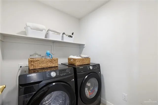 a kitchen with stainless steel appliances granite countertop a sink a stove and a dining table with white cabinets