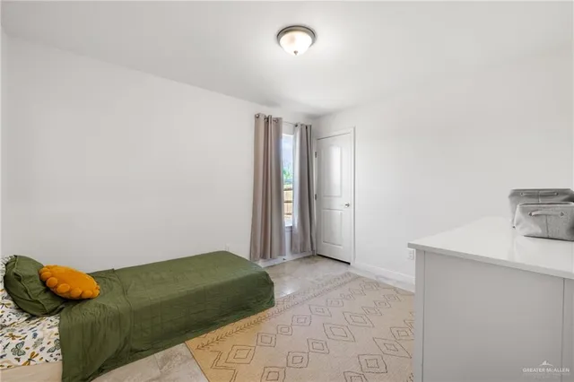 a bedroom with a bed and blue plant