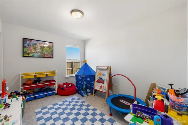 a bedroom with furniture and a lamp