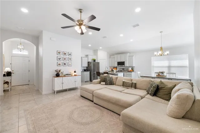 a living room with furniture and a ceiling fan