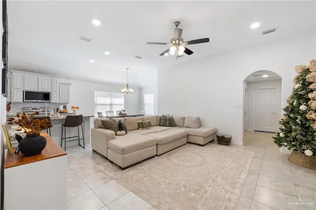 a living room with furniture and a chandelier
