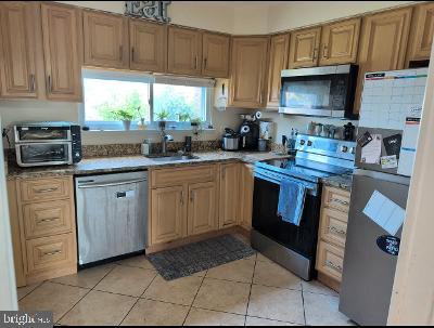 21 Ojibway Road Randallstown, MD 21133 - Photo 3 of 6 a kitchen with stainless steel appliances granite countertop a stove a sink dishwasher and a microwave oven with cabinets