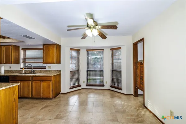 a view of a kitchen with a sink and a window