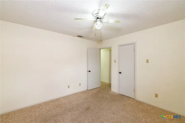 a view of a chandelier fan in big room
