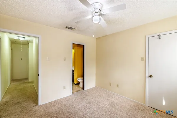 a view of a livingroom with a chandelier fan