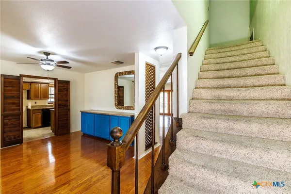 a view of entryway and hall with wooden floor