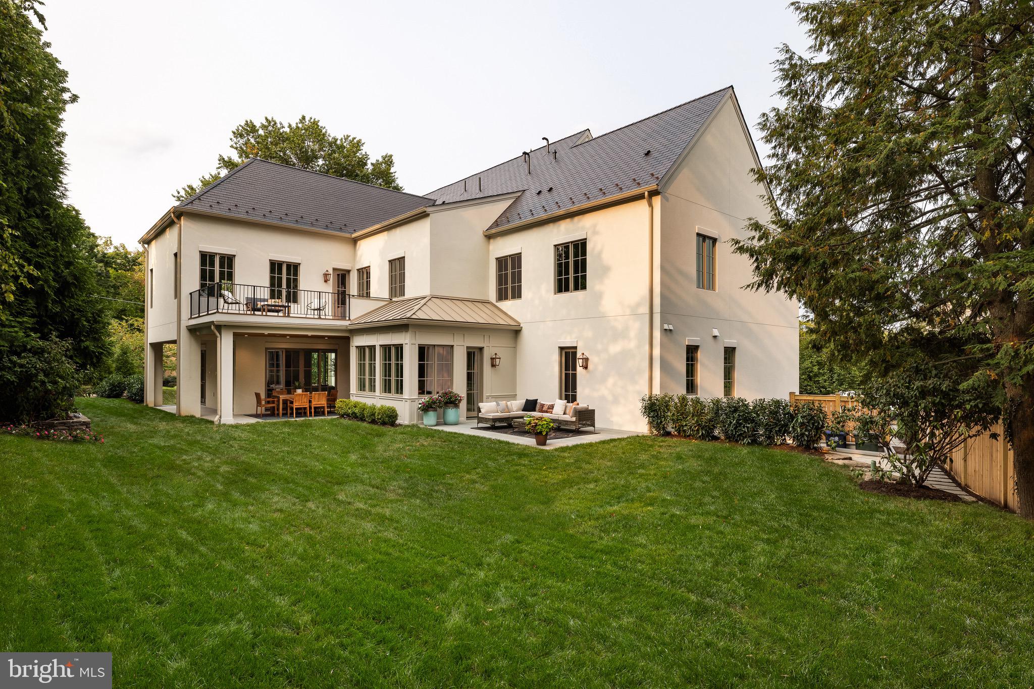 2934 Ellicott Terrace Northwest Washington, DC 20008 - Photo 4 of 55 a view of a white house with a big yard and large trees