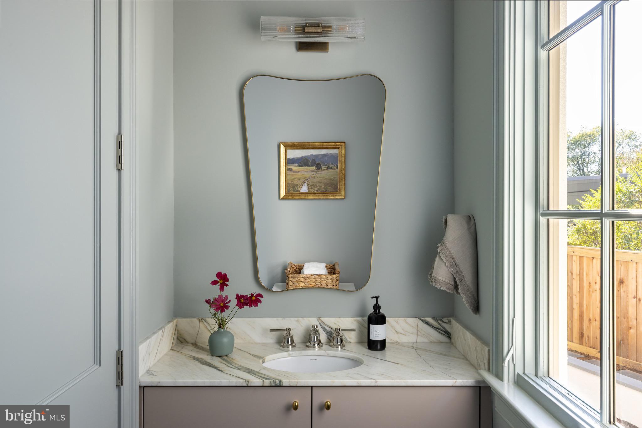 2934 Ellicott Terrace Northwest Washington, DC 20008 - Photo 8 of 55 a bathroom with a granite countertop sink and a mirror