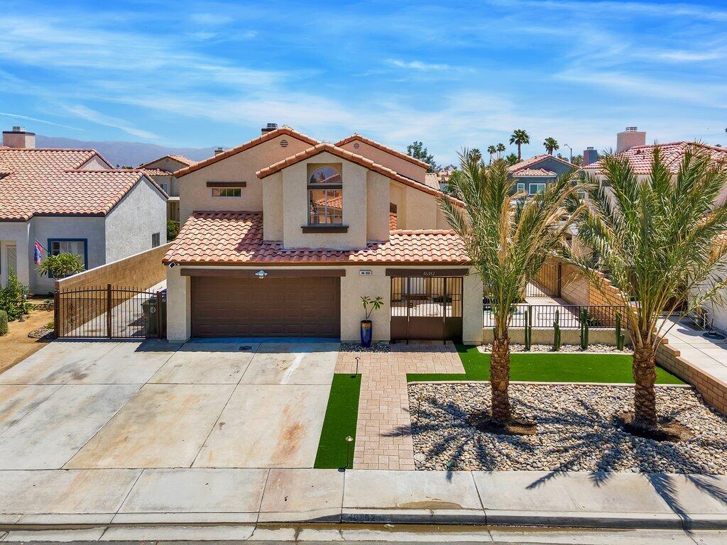 46352 Willow Lane Indio, CA 92201 - Photo 6 of 131 a front view of a house with garden