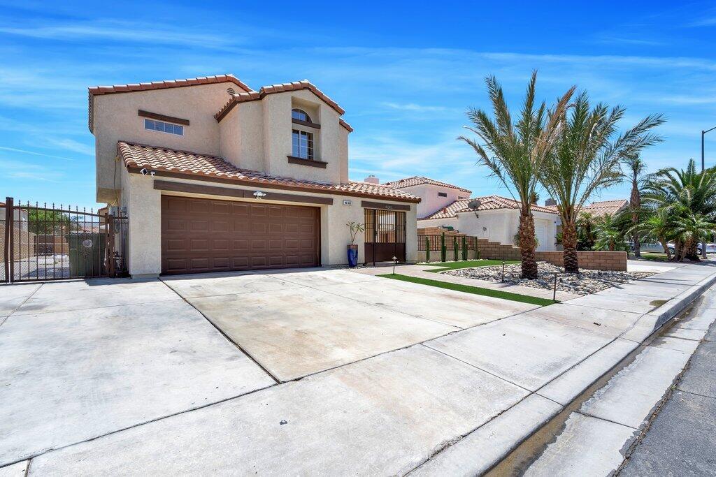 46352 Willow Lane Indio, CA 92201 - Photo 7 of 131 a front view of a house with a yard