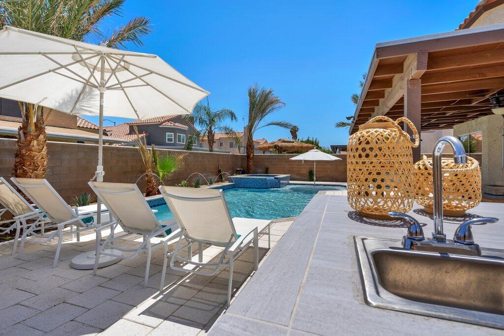 46352 Willow Lane Indio, CA 92201 - Photo 76 of 131 a view of a patio with table and chairs under an umbrella