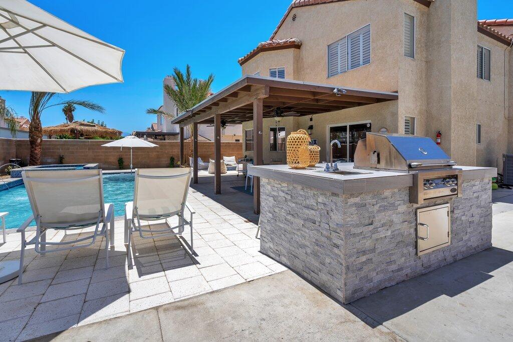 46352 Willow Lane Indio, CA 92201 - Photo 77 of 131 a view of a patio with table and chairs under an umbrella