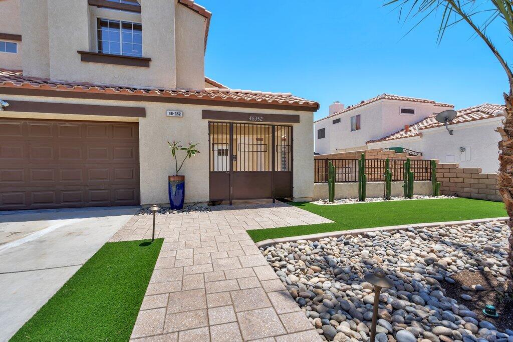 46352 Willow Lane Indio, CA 92201 - Photo 8 of 131 a front view of a house with a yard and garage