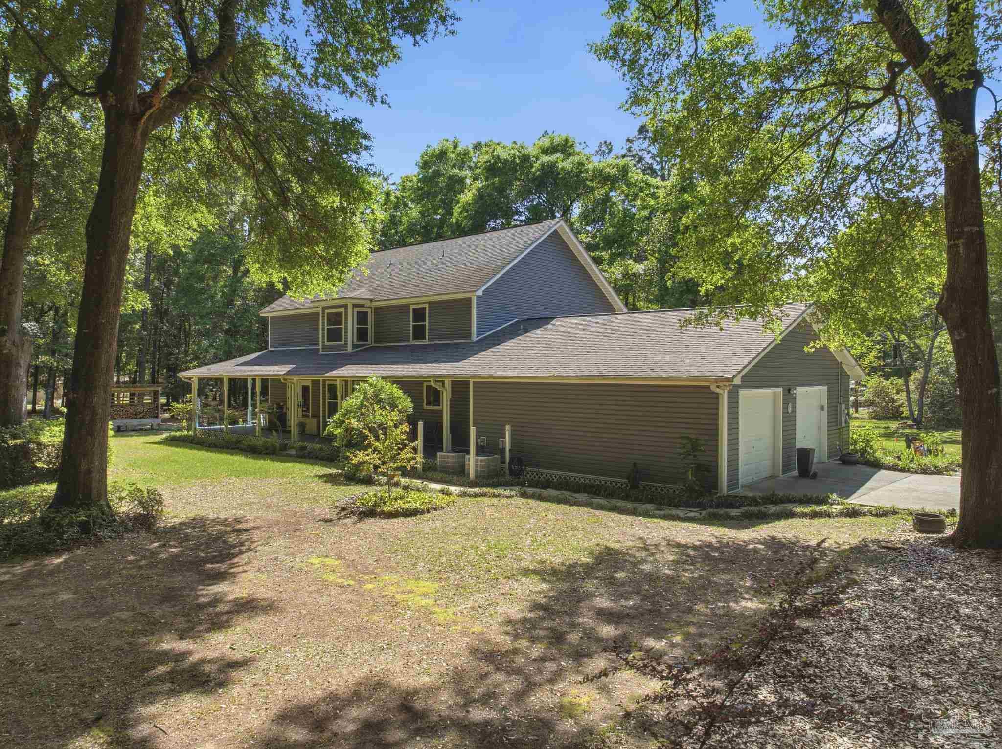 6930 Summit Way Milton, FL 32570 - Photo 54 of 71 a view of a house with backyard and trees